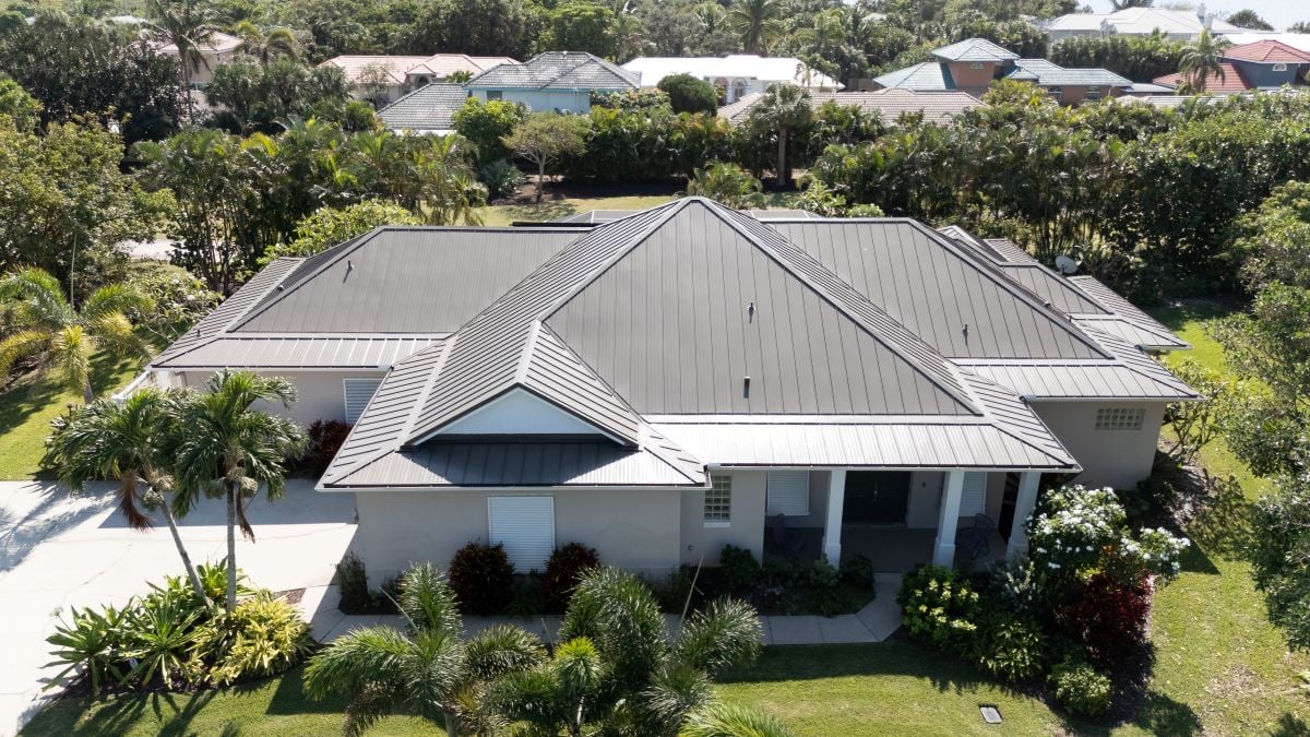 light grey metal roof residential roofing service big house with backyard inside neighbourhood how to install metal roofing