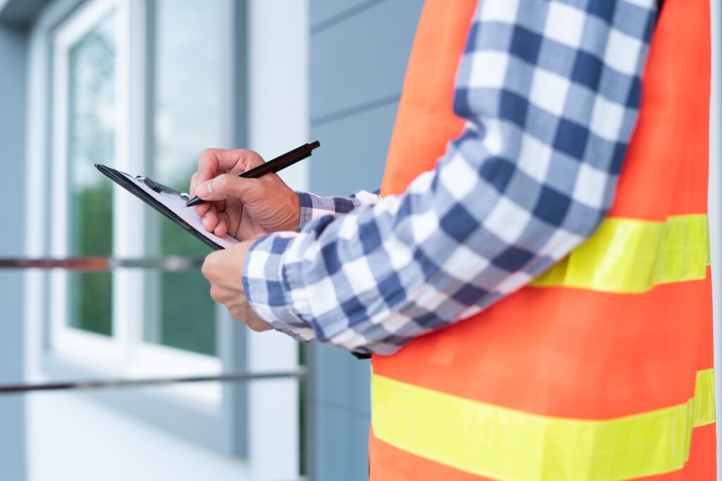 The inspector or engineer is checking the building structure and house roof specifications. After the renovate is complete roof inspection cost