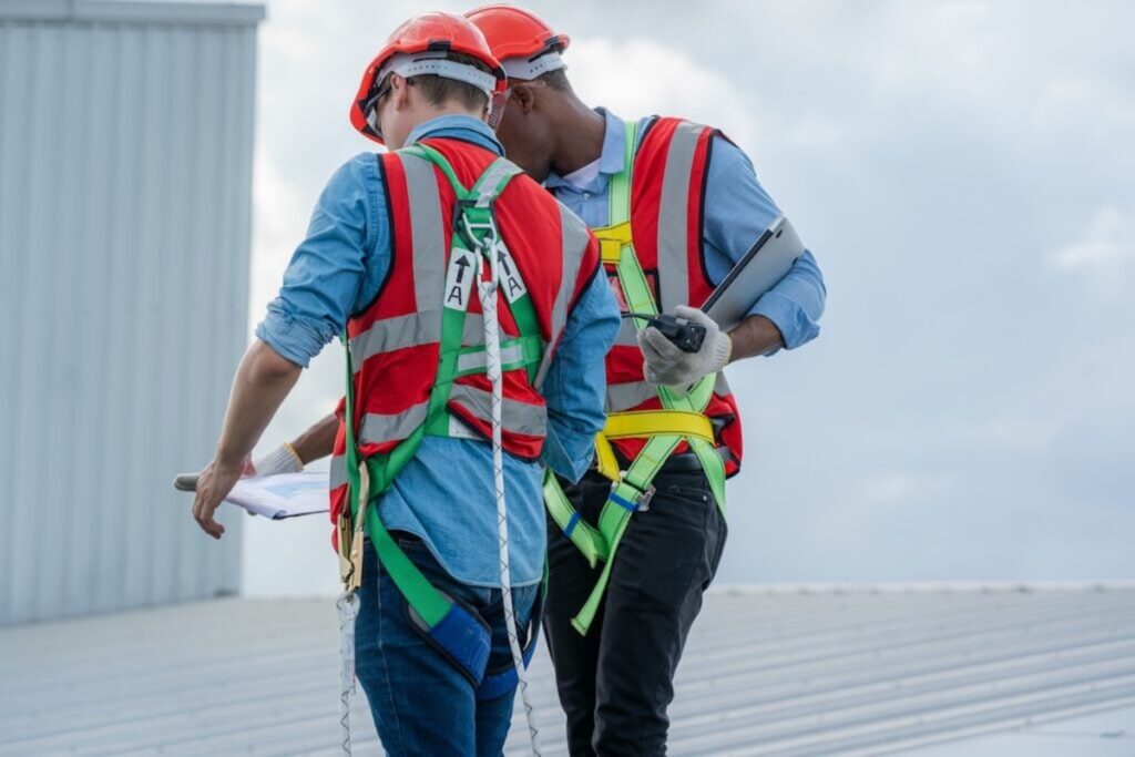 two me inspecting a commercial roof
