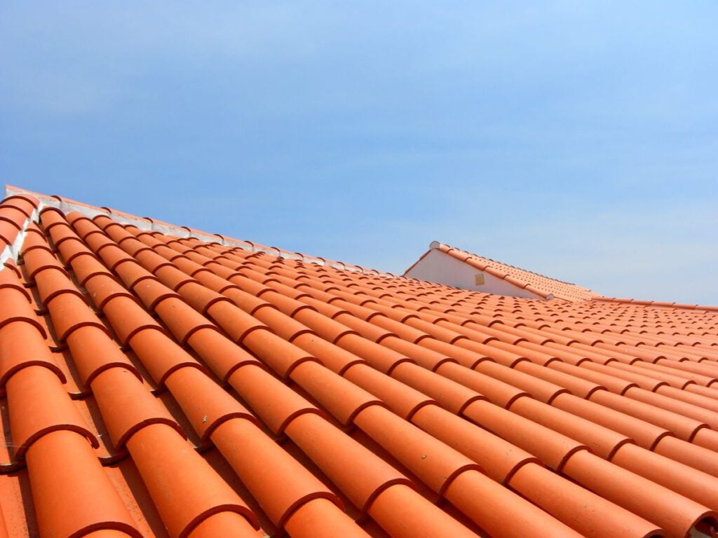 Red tile roof under blue sky