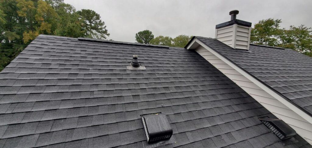best roofing material for Florida homes grey shingles roof with chimney white walls