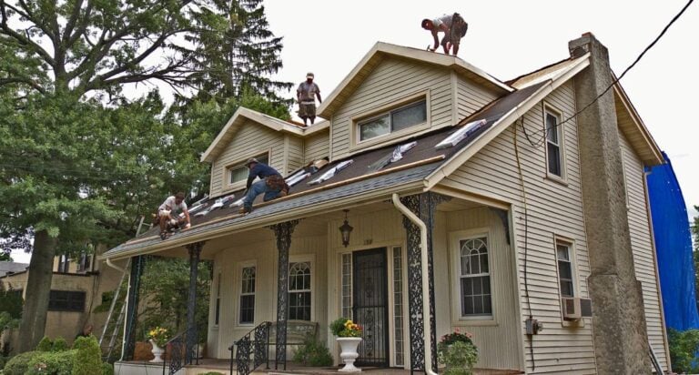roof leak repair cost Florida Roof Bros working on roof damaged by storm