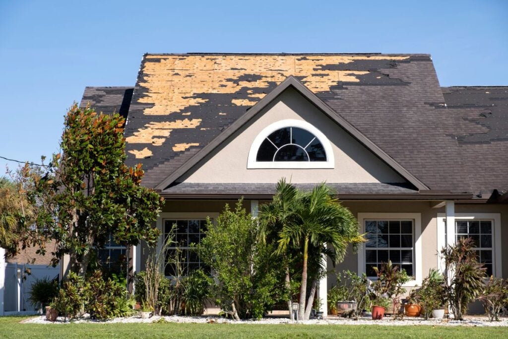 storm damage roof big family house shingles fall after hurricane