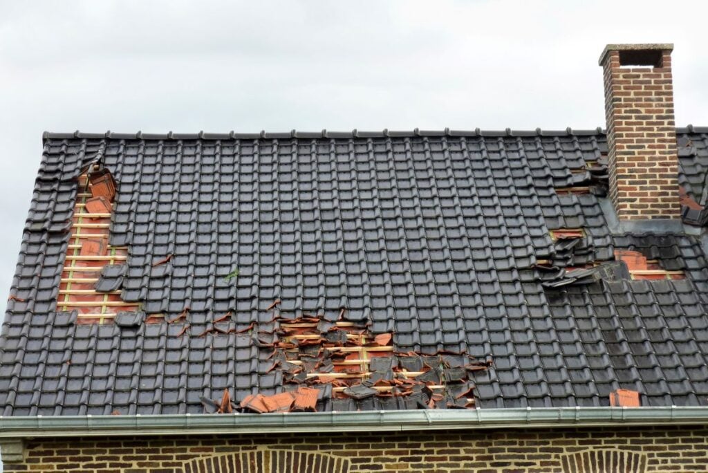 storm damage roof tiles falling after hurricane brick walls chimney