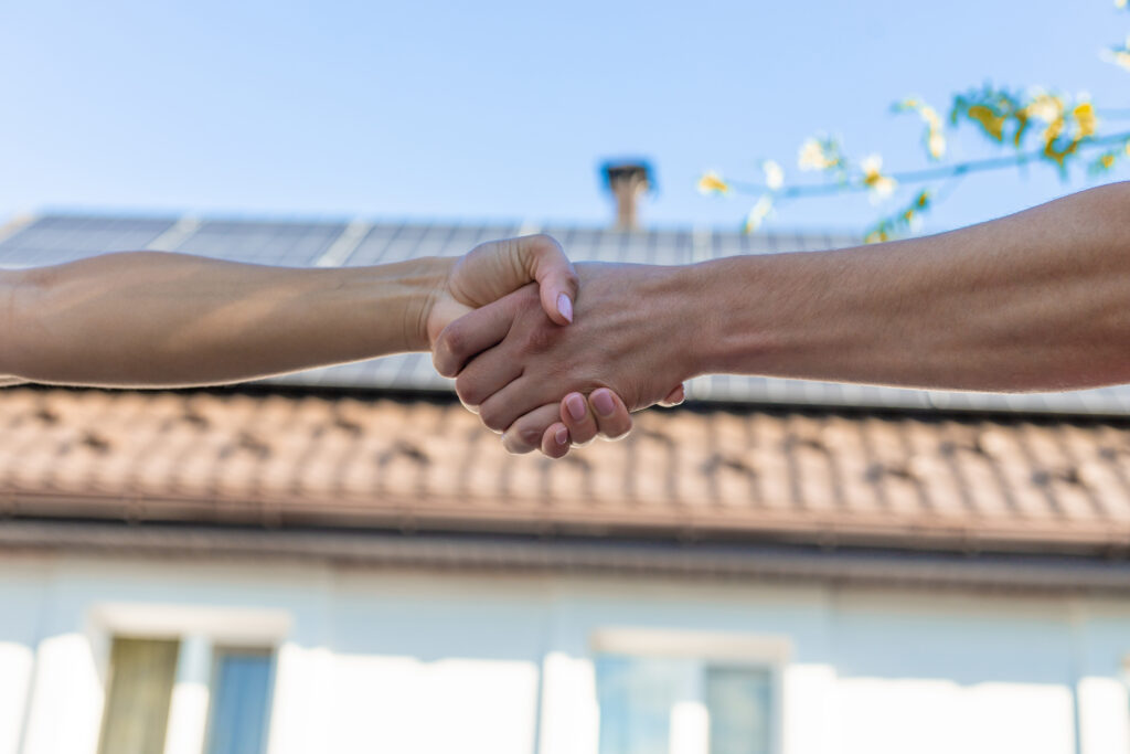 Handshake on roof background