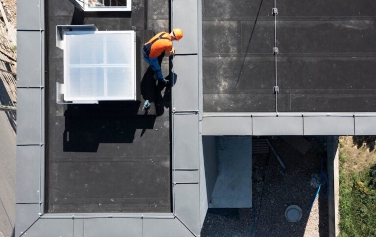 Roof worker on flat roof