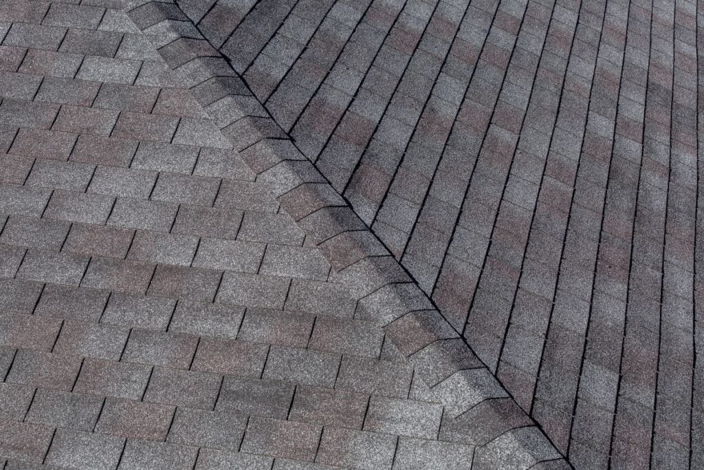 gaf vs certainteed light grey and red shingles close up