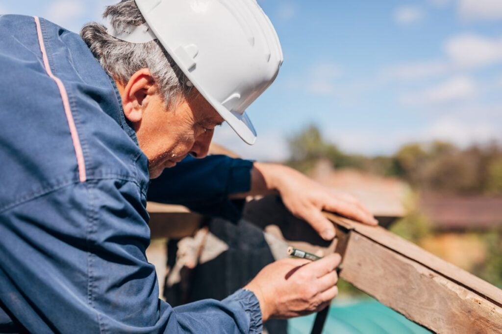 how to measure a roof worker using pencil to work on top of
