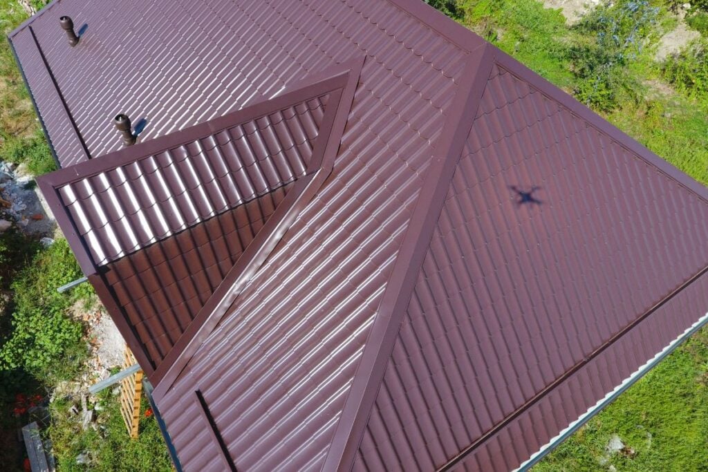 standing seam vs exposed fastener big brown metallic roof corrugated aerial view